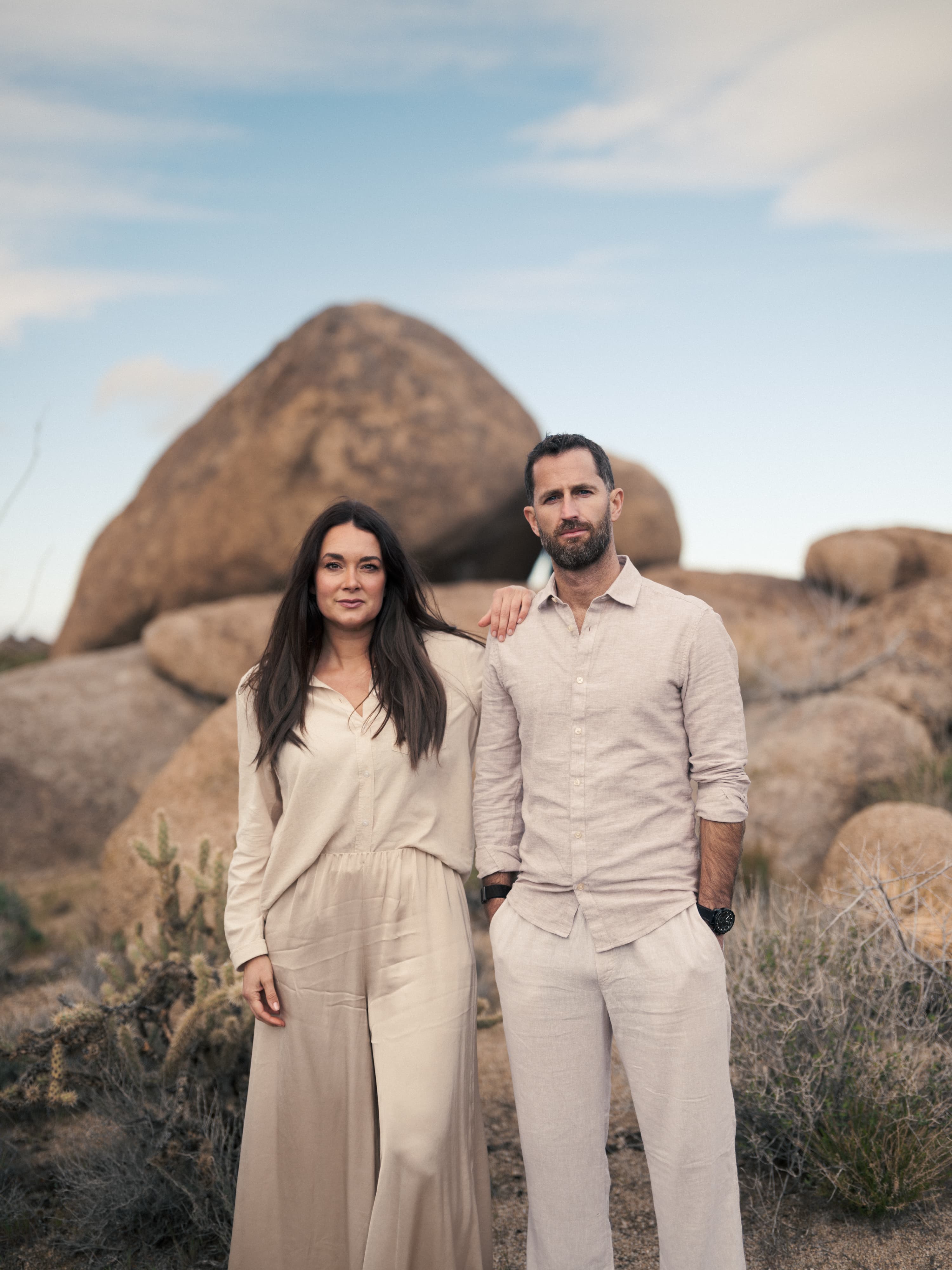 Jared and Annette Thurmon, founders and hosts of Santerra, standing in the boulder field