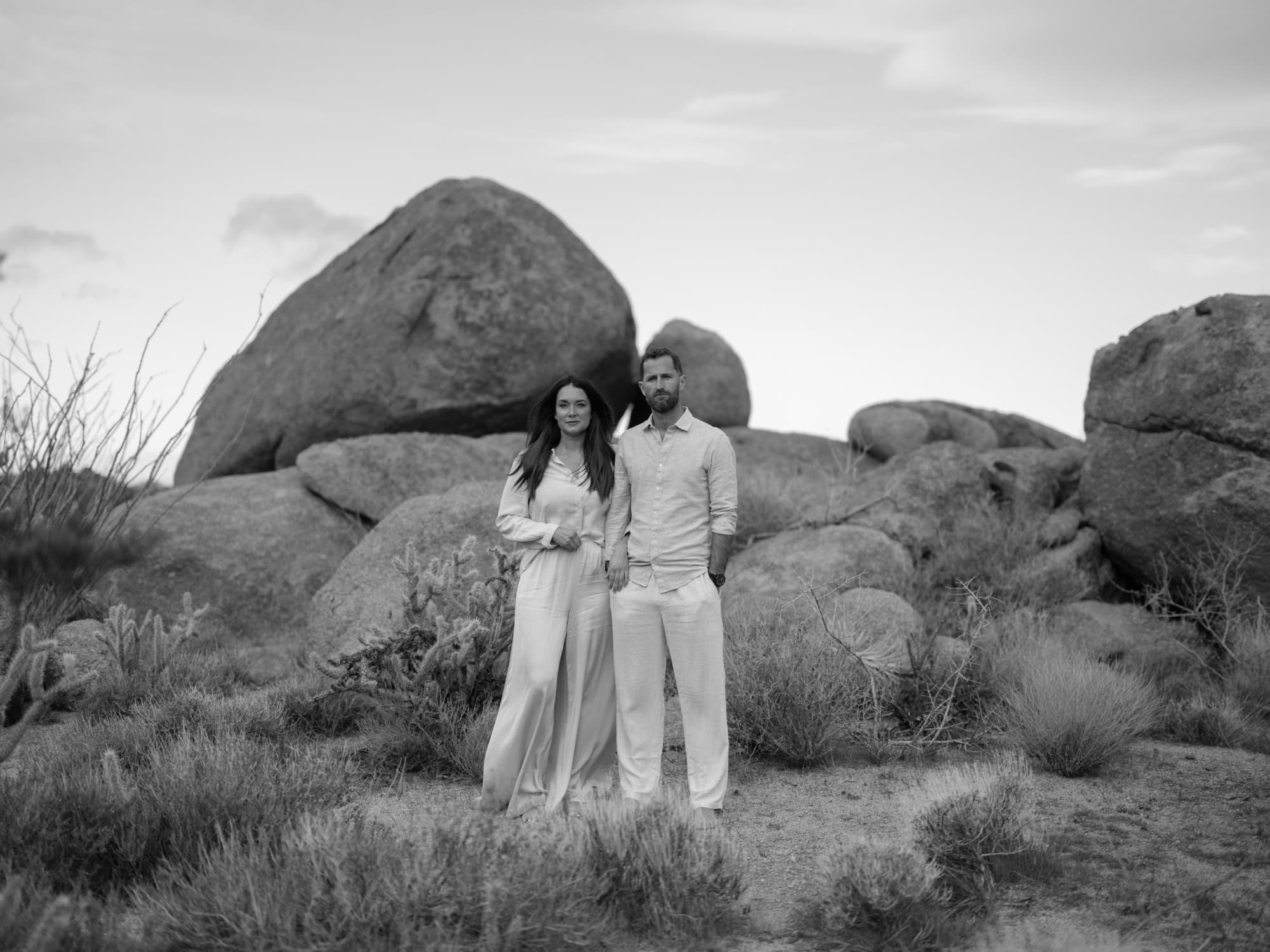 A couple standing together in front of the boulder field