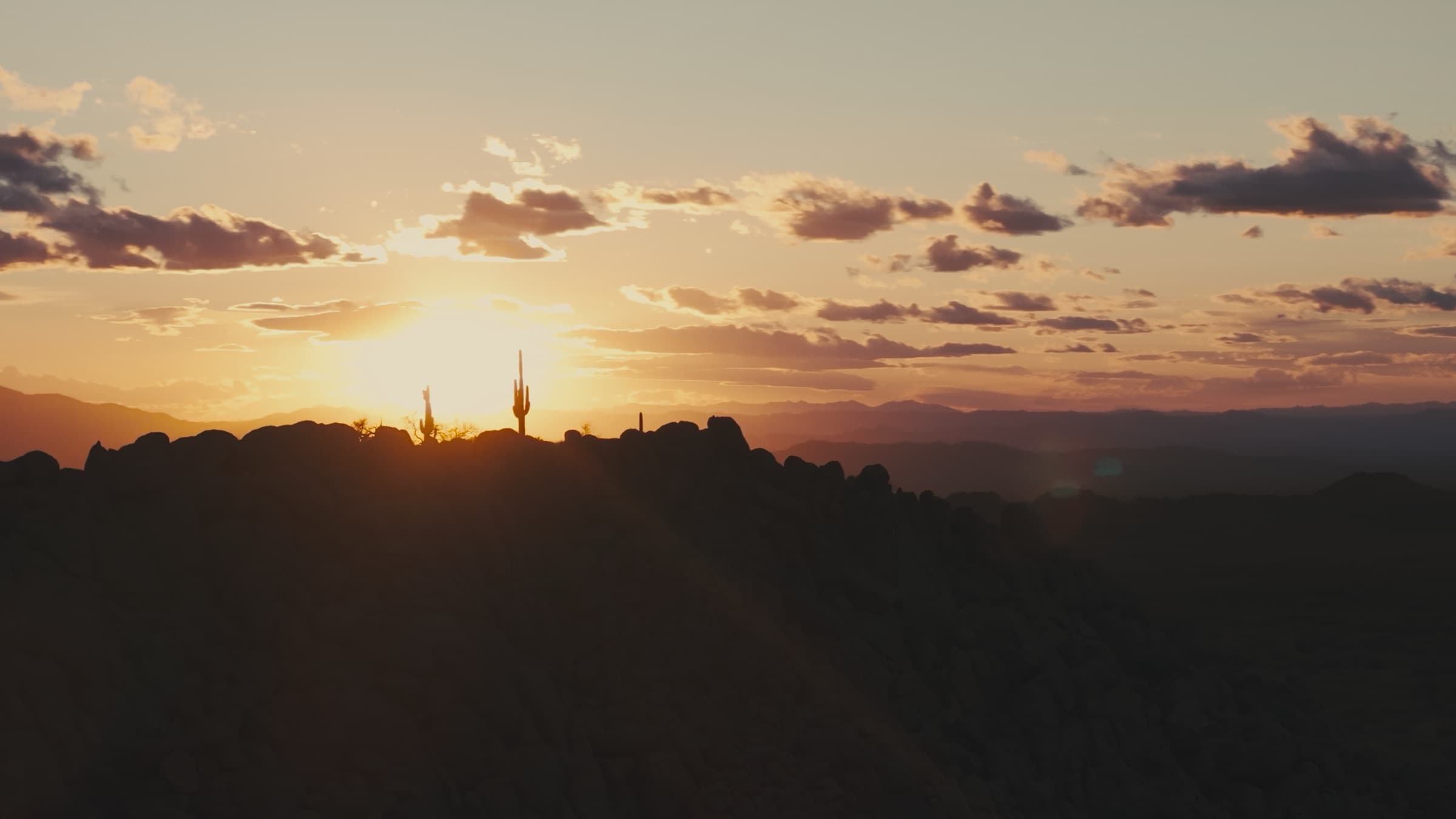 Aerial view of the Box Canyon ridgeline as the sun drops behind the range