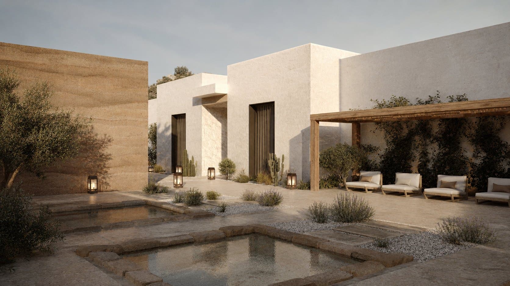 A desert courtyard with two square sunken stone pools, an olive tree, lanterns on the paving, and a wooden pergola sheltering four cushioned daybeds along one wall.